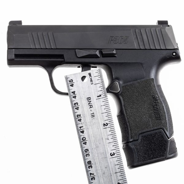 MTX 365 +3 installed onto magazine and placed in pistol. Ruler showing the MTX adds 5/8" of an inch to the pistol when installed.