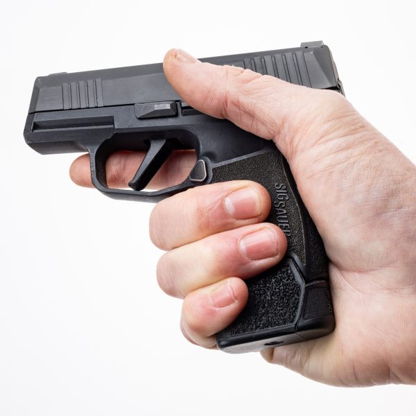 P365 california shown in a man's hand with MTX 365 plus 0 facing left. Man has complete grip on California P 365